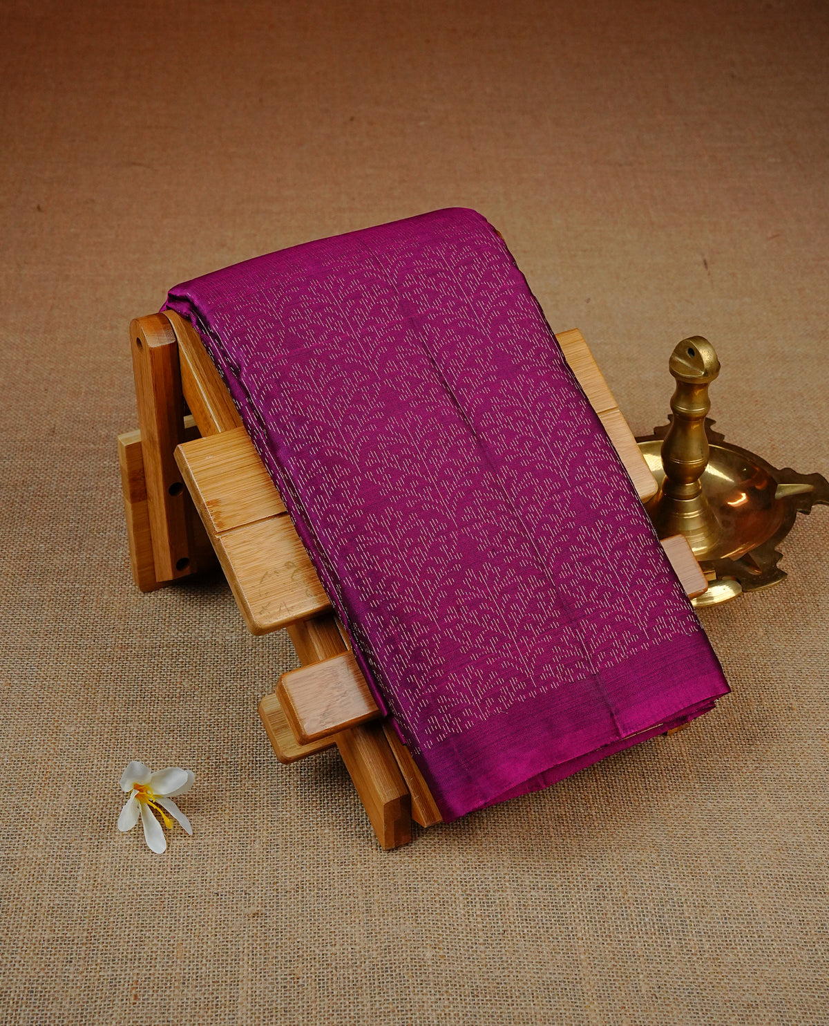 Magenta Colour soft silk saree featuring elegant self woven leaf motifs across the body, complemented by a richly woven self design pallu, paired with a matching plain blouse piece.