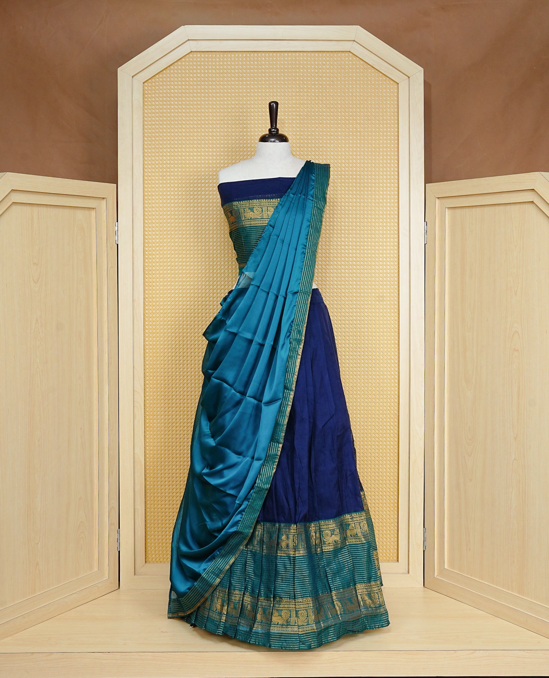 Navy Blue colour Dhavni set Featuring Navy Blue Skirt and Contrast Green colour with Zari border, paired with UnStitched Blouse & Elegant Dupatta.