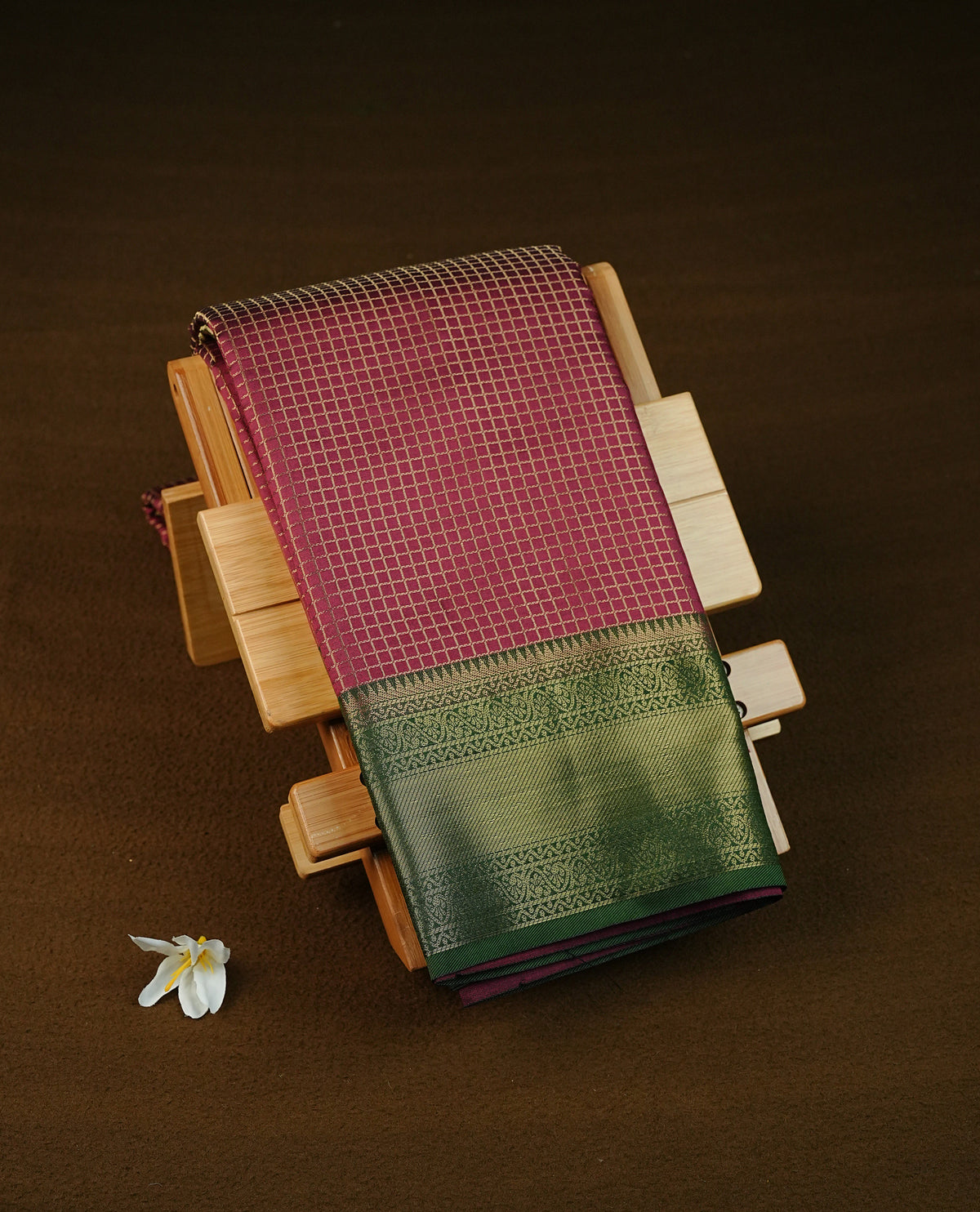Wine colour semi silk saree featuring gold zari check patterns on body, contrast green colour with traditional border on body, grand pallu comes with matching blouse piece