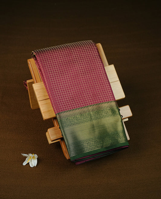Wine colour semi silk saree featuring gold zari check patterns on body, contrast green colour with traditional border on body, grand pallu comes with matching blouse piece