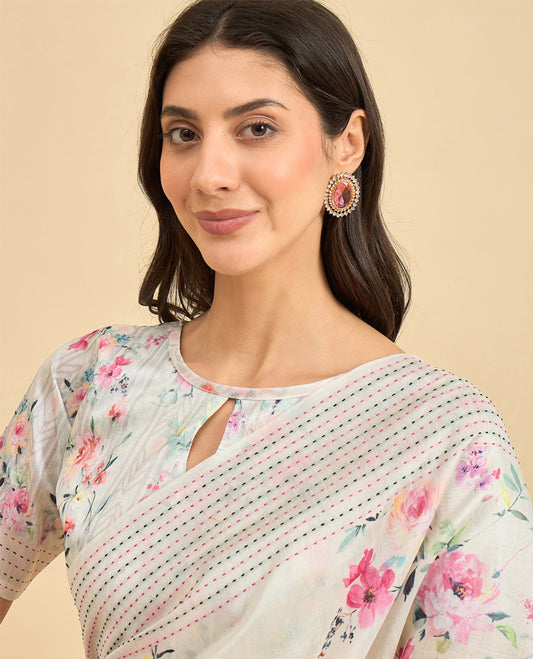 Cream toned semi tussar saree featuring delicate multicolour floral prints on the body, accented with a pastel hued Katha style stitched border and green & grey printed pallu Comes with a matching floral printed blouse for a graceful look.