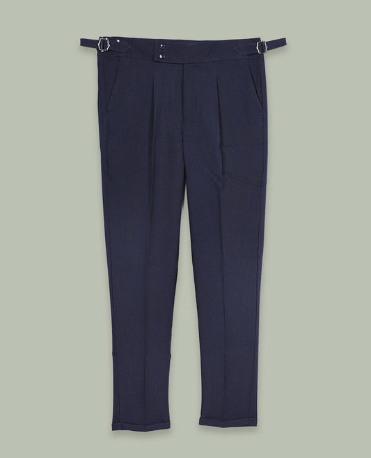 Navy blue colour men’s pant featuring a clean waistband with side buckle adjusters, neat front pleats, slant pockets and back welt pockets, finished with a straight leg fit.