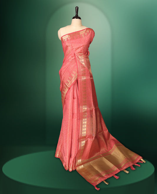 Peach Pink colour saree featuring subtle golden woven motifs on the body, complemented with a rich golden zari border and pallu, and paired with a matching blouse