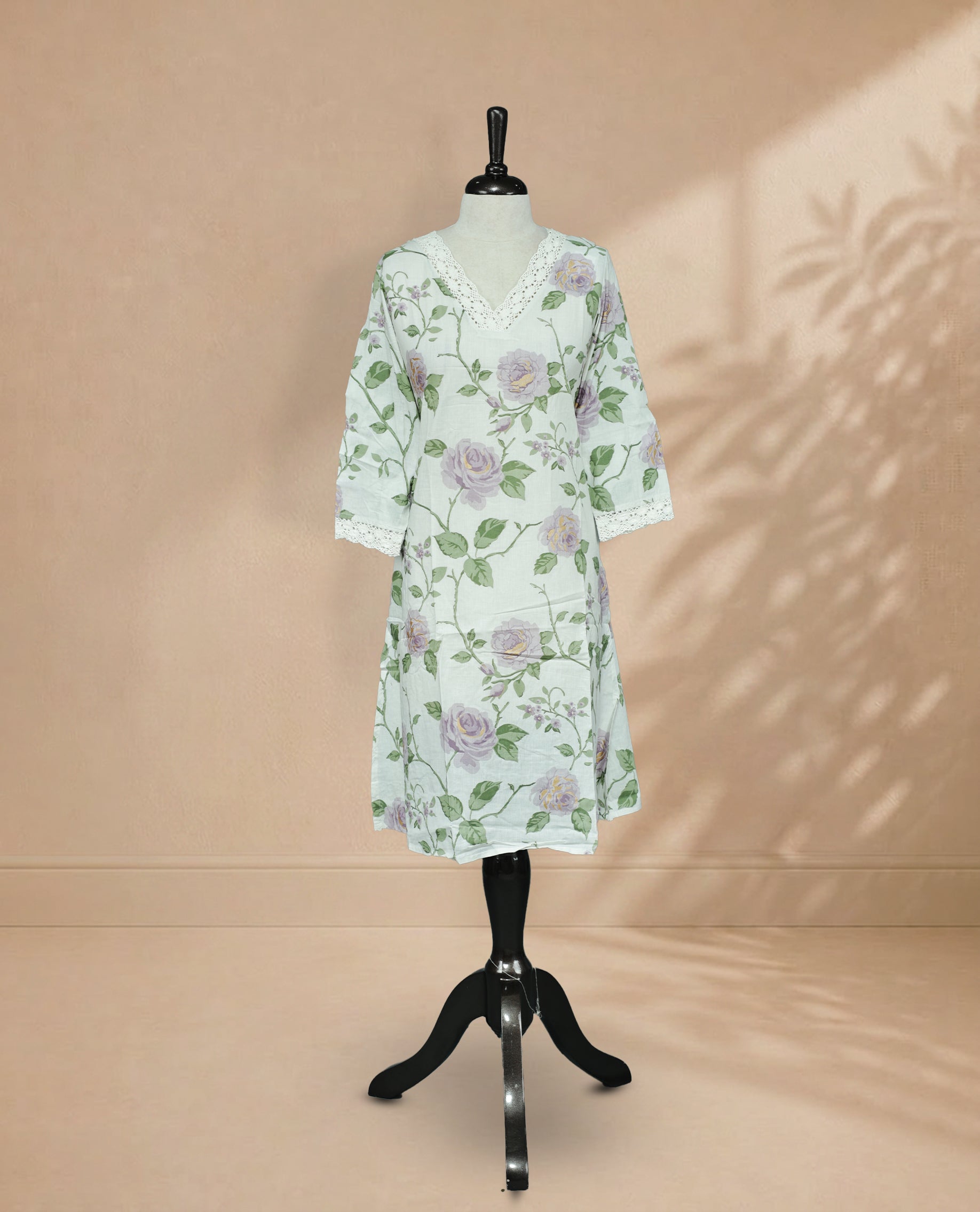 Off White Kurti featuring a delicate floral print with lavender roses and green leaves, a V-shaped neckline adorned with white lace detailing, and 3/4 sleeves finished with matching lace borders