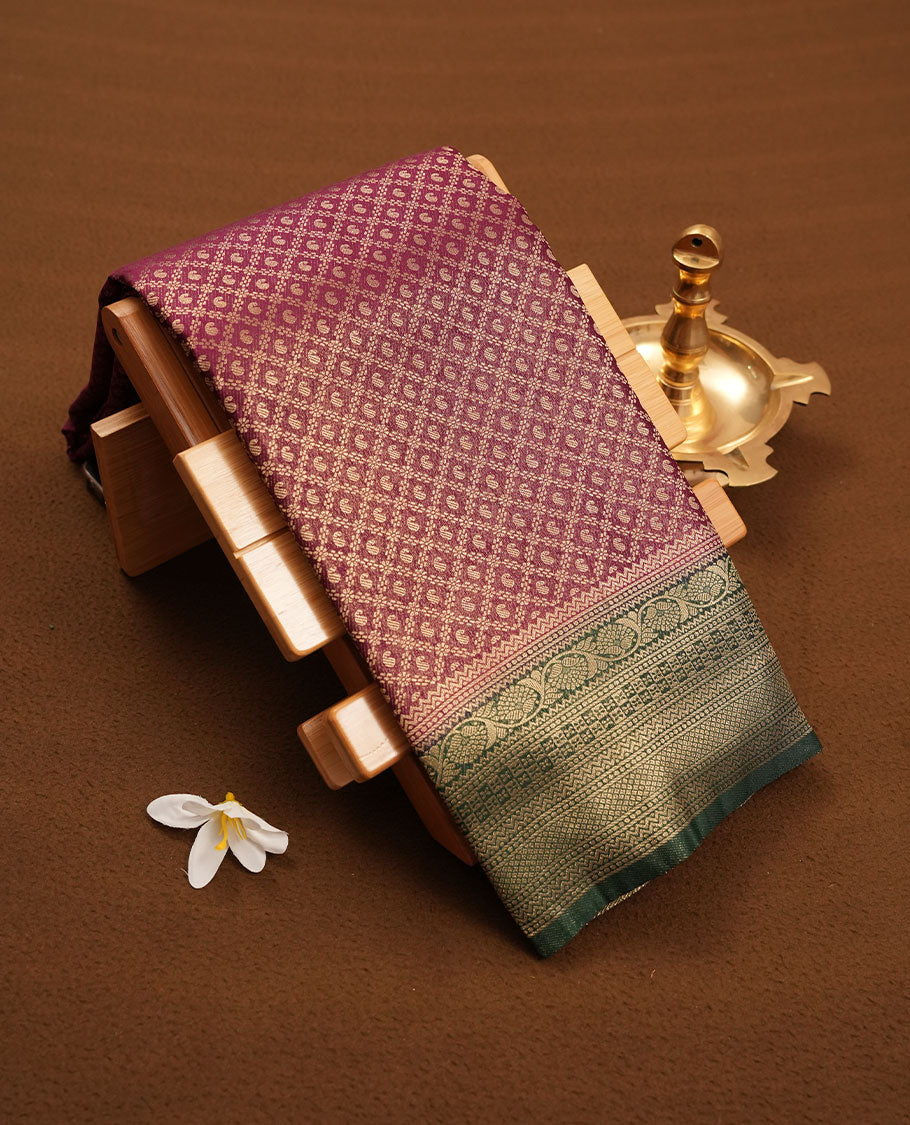 Grape Purple colour semi silk brocade saree featuring intricate Gold Floral kodi & leaf patterns across the body, complemented by a contrast green colour woven border and pallu, paired with a matching blouse.