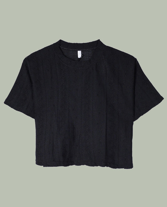 Black short-sleeve crop top with round neckline and subtle all-over self-textured geometric pattern.