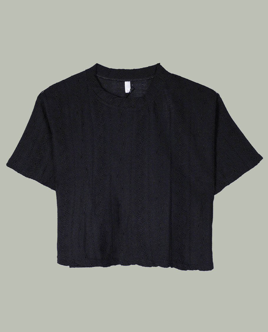 Black short-sleeve crop top with round neckline and subtle all-over self-textured geometric pattern.