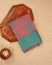 Dusty onion colour silk cotton saree featuring aqua green colour thread motifs on body thread detiled contrast borders & pallu, comes with matching blouse piece