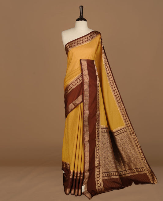 Yellow colour semi georgette saree featuring gold zari check pattern on body, complemented by contrast chocolate colour with zari border, paired with matching blouse piece.