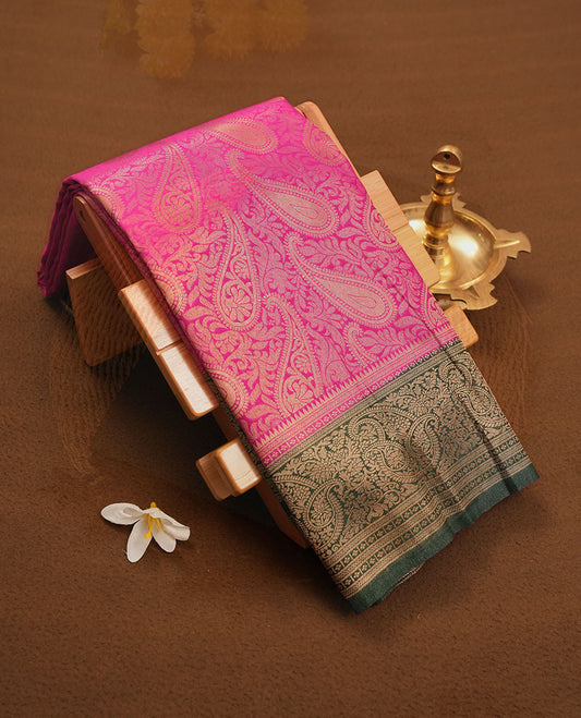 Magenta colour semi silk brocade saree featuring intricate Gold Floral kodi & leaf patterns across the body, complemented by a contrast Green colour woven border and pallu, paired with a matching blouse.