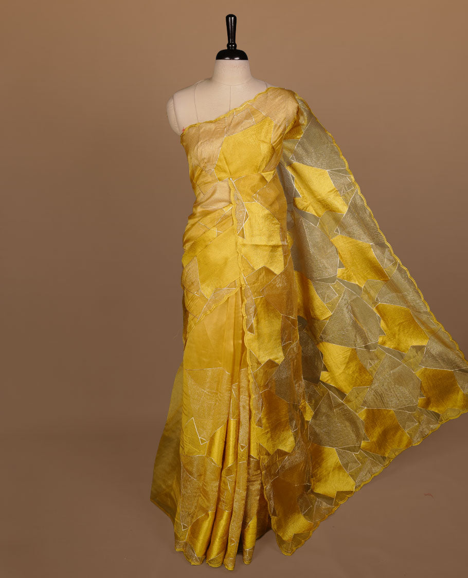Yellow colour Organza designer saree featuring a thread geometric pattern across the body, enhanced with a piping border and cut beats work on matching blouse piece.