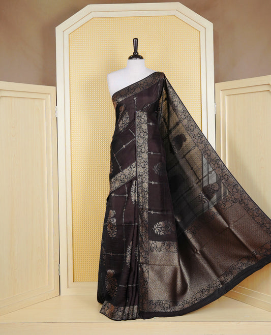 Black colour semi banaras tussar georgette saree featuring gold zari floral pattern on body, finished with gold zari floral motifs on border and paired with matching blouse piece.