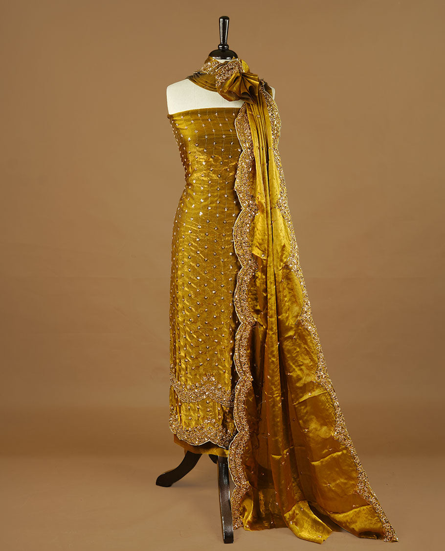 Olive colour churidhar material featuring cut beads and sequins work on the body, paired with a matching unstitched bottom and worked dupatta.