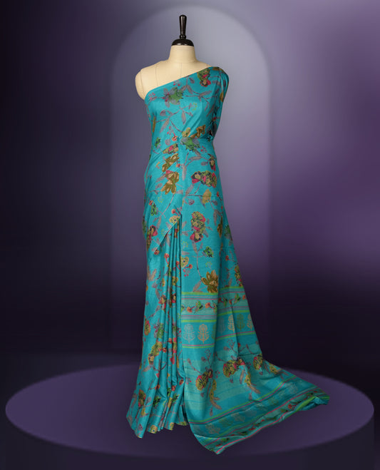 Turquoise Blue colour saree enhanced with a vibrant olive green,maroon and grey colour floral prints on body & pallu, and  comes with a matching blouse.