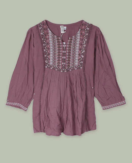 Mauve three-quarter sleeve tunic top with round neckline, intricately patterned embroidered yoke, front pleats, side lace inserts, and scalloped embroidered cuffs.