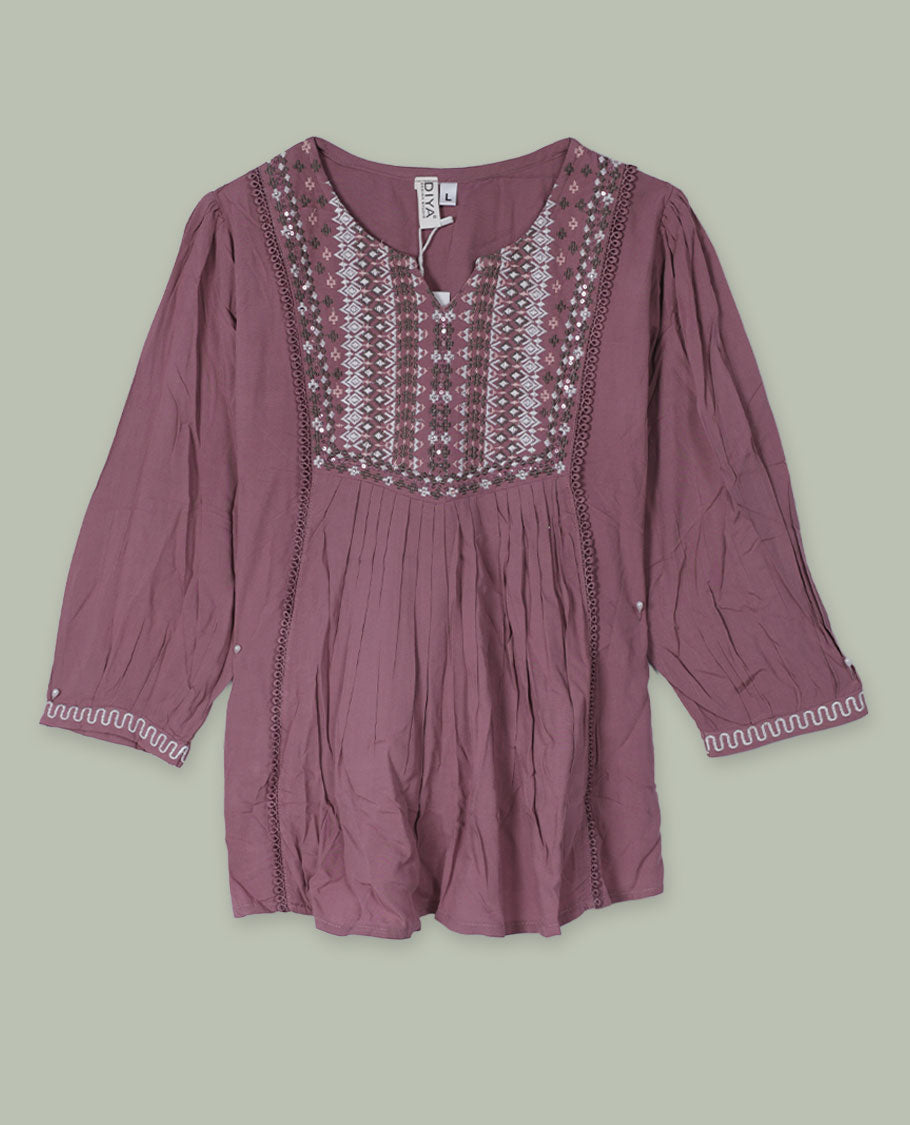 Mauve three-quarter sleeve tunic top with round neckline, intricately patterned embroidered yoke, front pleats, side lace inserts, and scalloped embroidered cuffs.