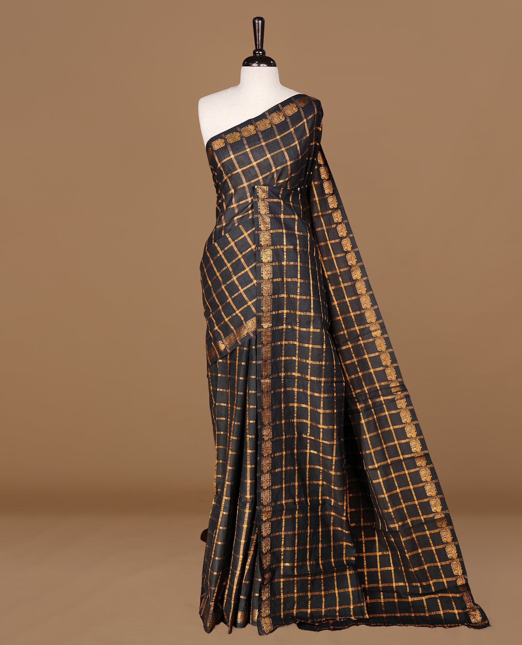 Black colour Sungudi cotton saree Featuring gold Zari check on body, complemented by gold zari peacock motif on self colour border, paired with matching blouse piece.