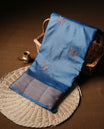 Teal colour semi banaras tussar silk saree highlighting gold zari bird motifs on body, complemented by self colour with antique zari border, paired with matching blouse piece.