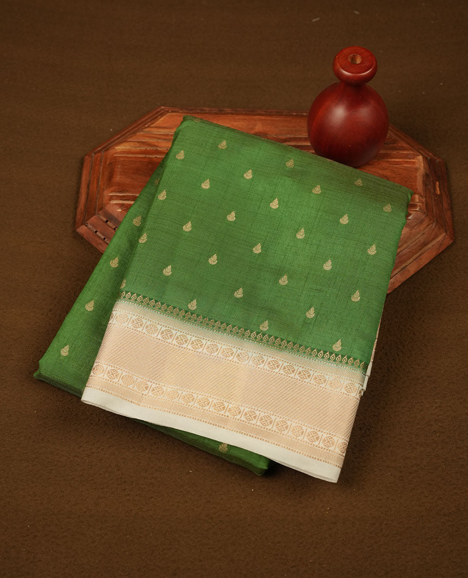 Green colour semi tussar saree featuring gold zari buttas across body, contrast cream colour gold zari border and comes with matching blouse piece.