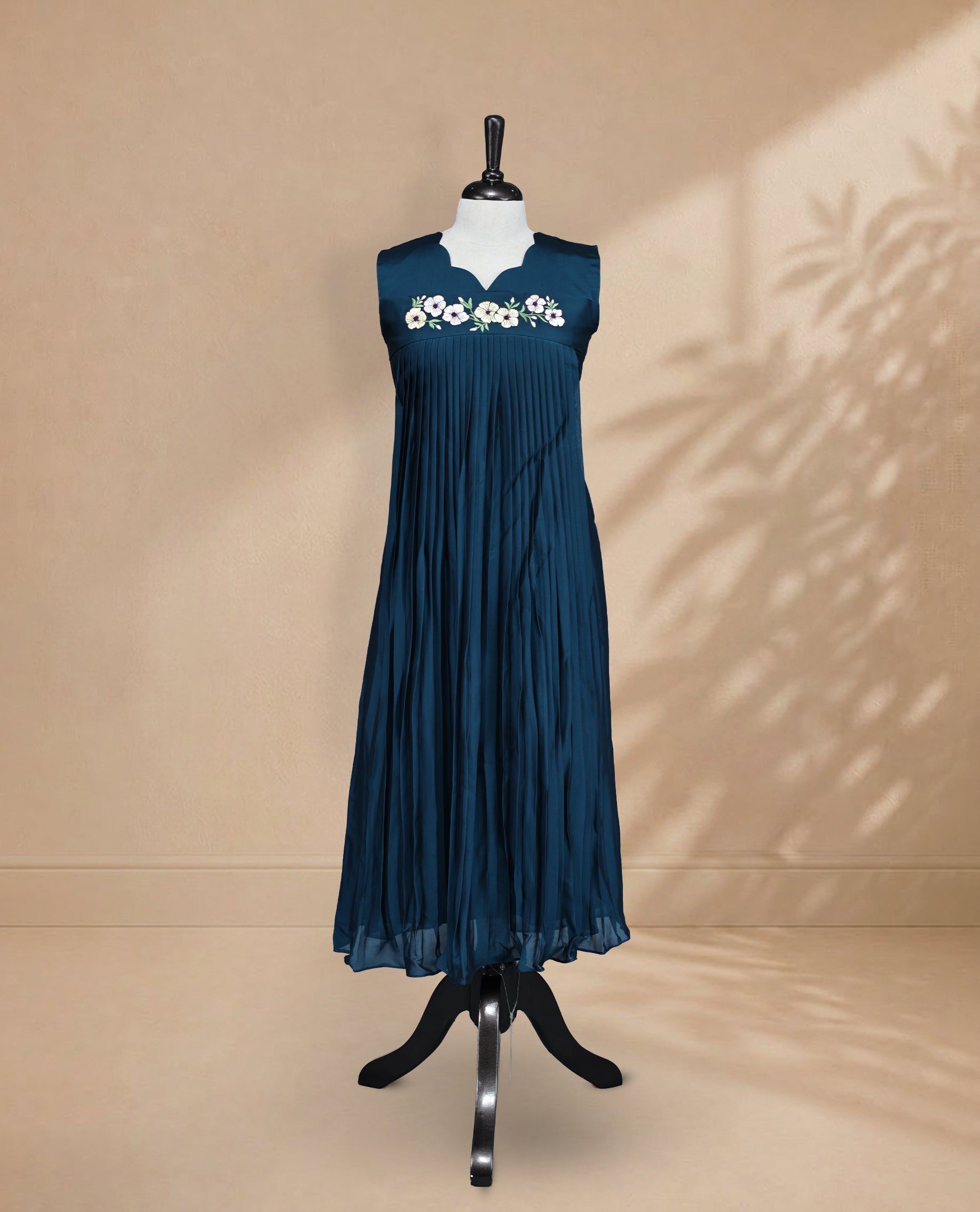 Teal Coloured Sleeveless Kurti Featuring a Designed Neckline, Floral Embroidery on the Body
