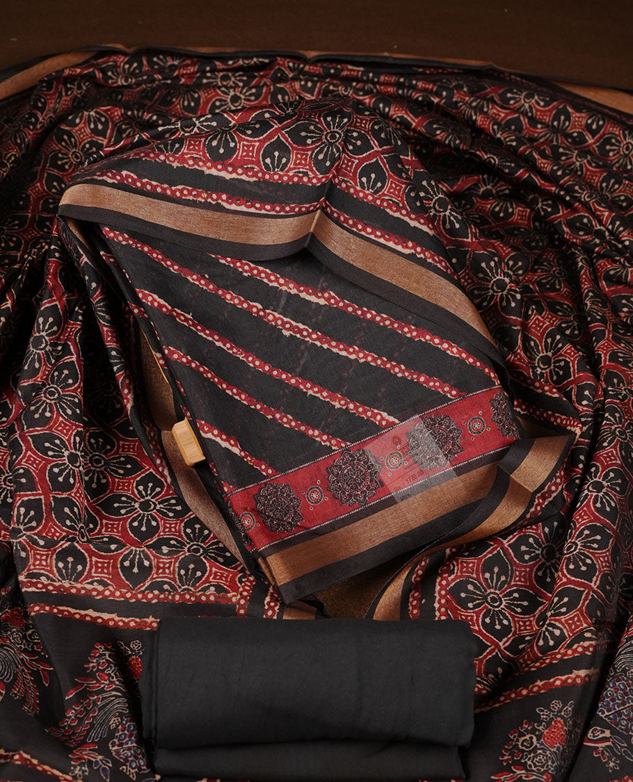 Black colour churidar material featuring printed body fabric, paired with a coordinated dupatta and matching solid bottom.