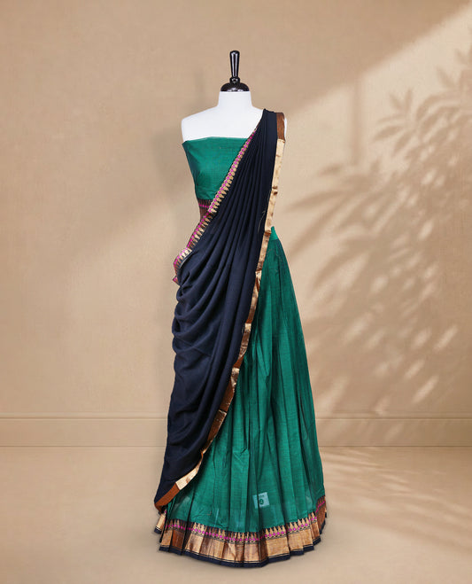 Green colour Half saree featuring Plain skirt with Zari border on contrast black colour border, Unstitched Blouse and matching dupatta.