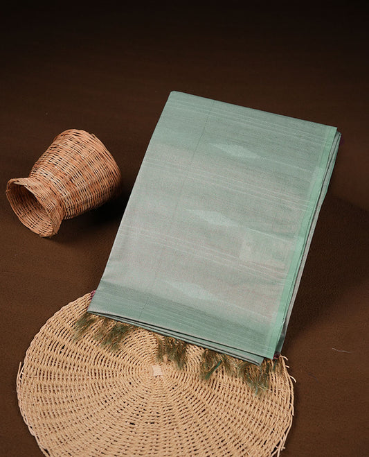 Light green colour semi jute saree highlighting gold zari stripped body with white motifs, without border and paired with matching blouse.