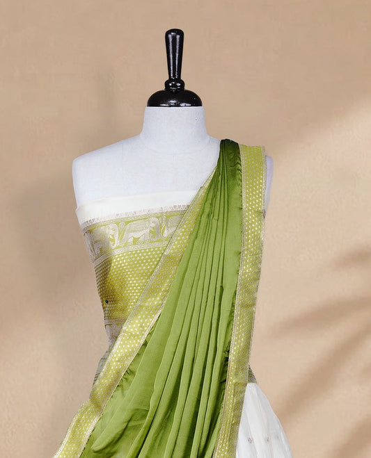 Cream colour Half saree featuring Gold zari buttas on skirt with Zari border on contrast Green colour border, Unstitched Blouse and matching dupatta.