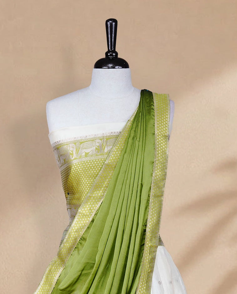 Cream colour Half saree featuring Gold zari buttas on skirt with Zari border on contrast Green colour border, Unstitched Blouse and matching dupatta.