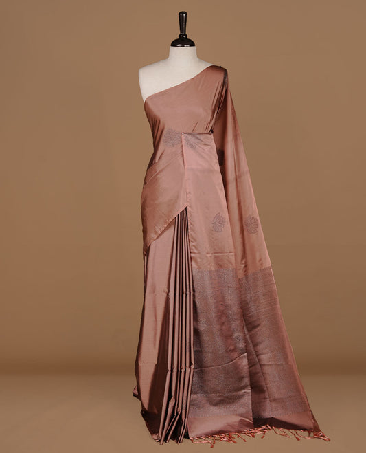 Dusty Cream soft silk saree features a sleek borderless design with intricate antique zari motifs, flowing into a seamless self colored pallu and a matching blouse piece.