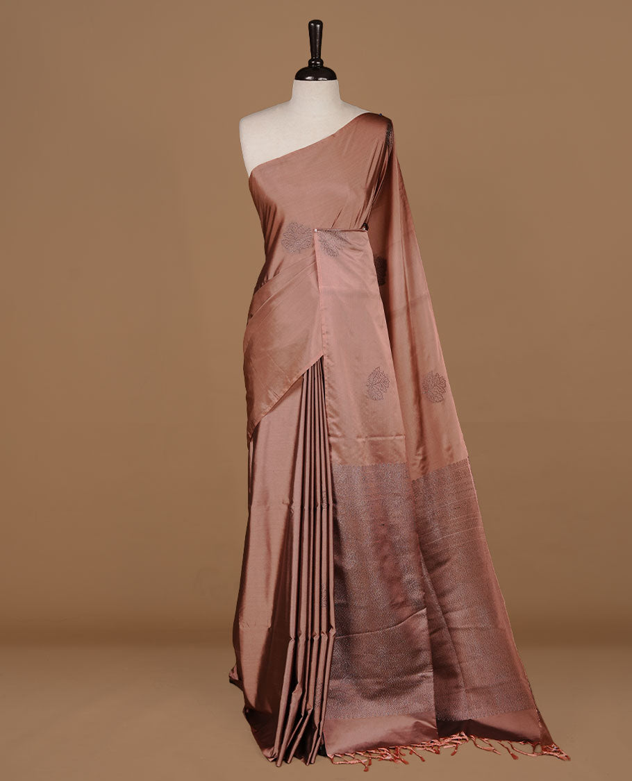 Dusty Cream soft silk saree features a sleek borderless design with intricate antique zari motifs, flowing into a seamless self colored pallu and a matching blouse piece.
