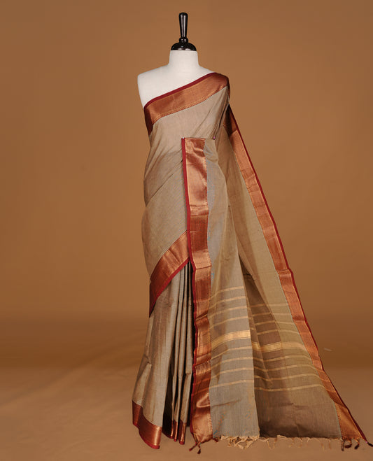 Greyish cream Colour Chettinad cotton saree featuring elegant plain body , complemented by contrast Maroon colour with traditional border, comes with matching blouse piece.