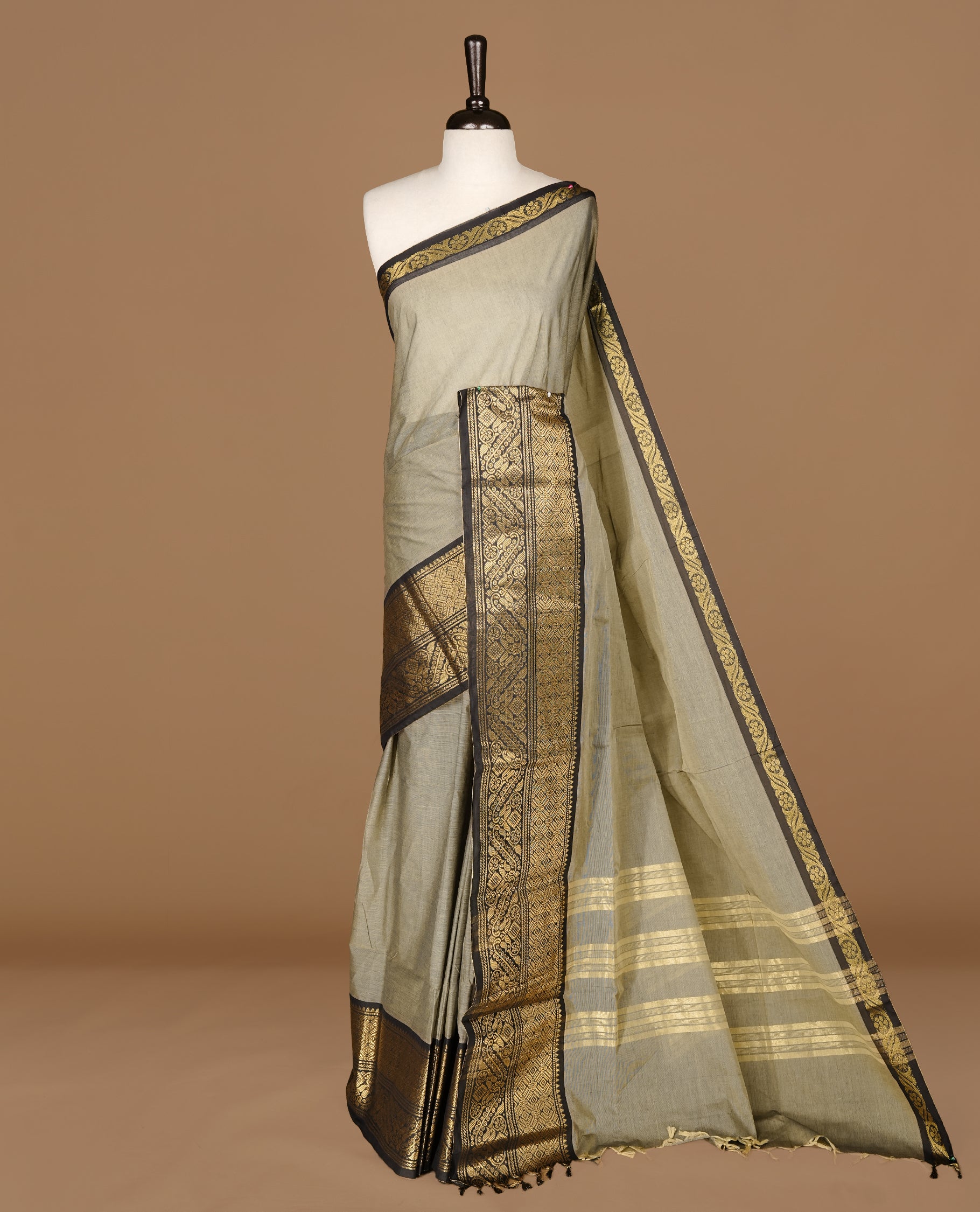 Grey Beige Colour chettinad cotton saree featuring Elegant plain body, complemented by contrast Black  colour with gold zari border, paired with matching blouse.