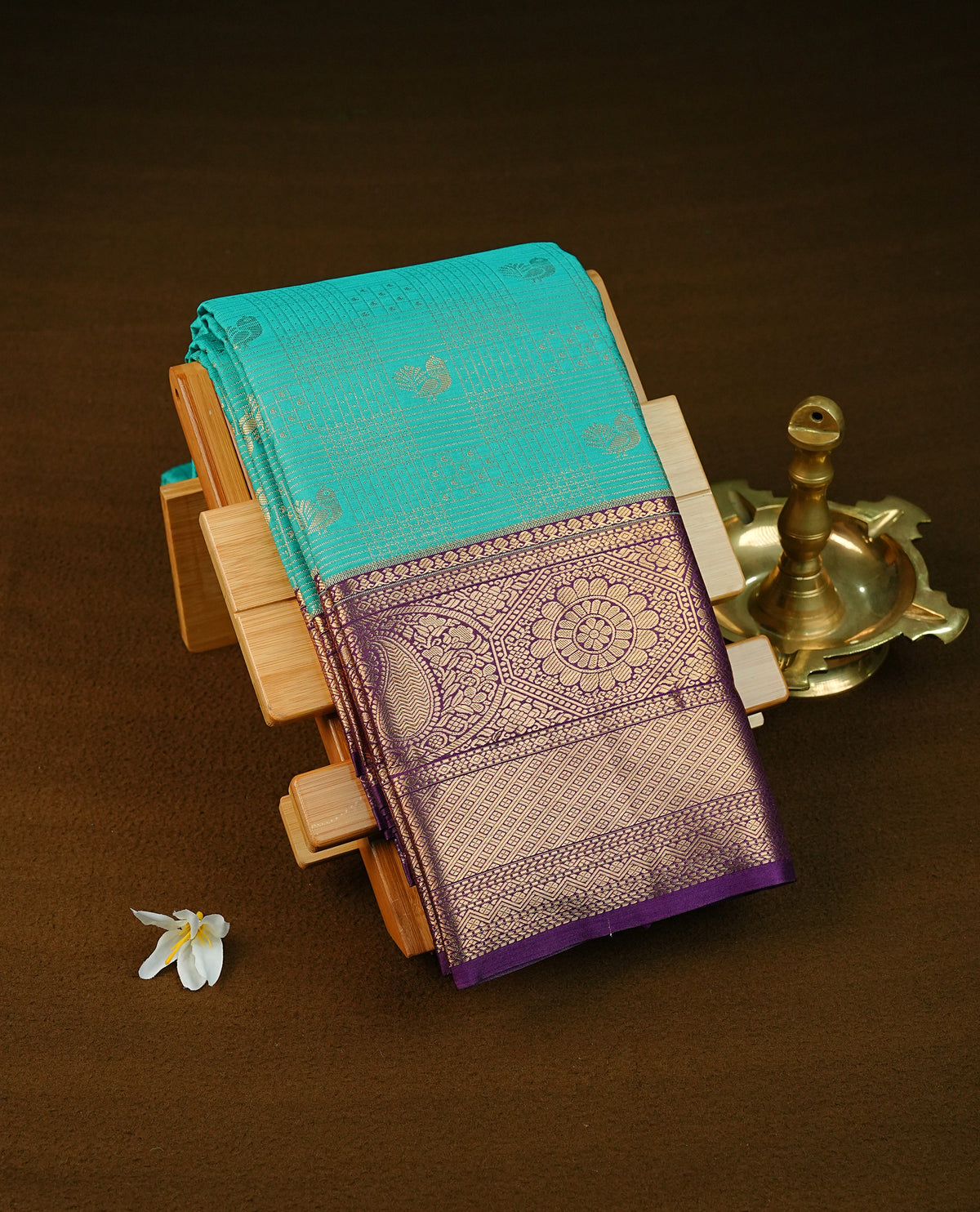 Aqua colour semi wedding saree featuring light gold zari check with peacock motifs across the body, complemented by contrast purple colour traditional border, Comes with a matching blouse piece.