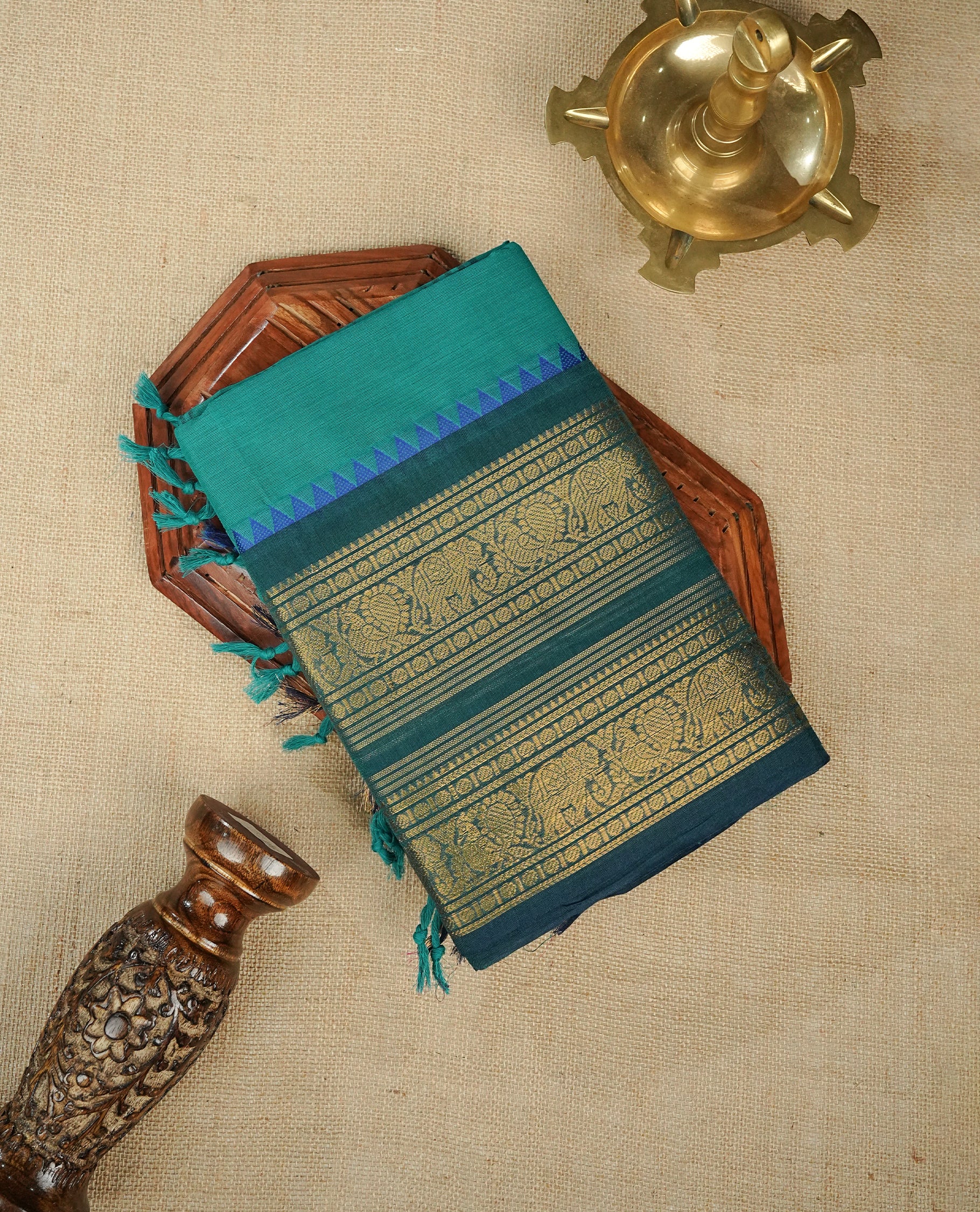 Teal colour chettinad cotton saree featuring Elegant plain body,Contrast Dark green colour with Gold zari border, comes with matching blouse piece.