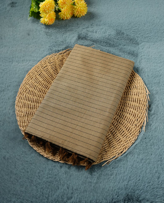 Dark Beige colour poly cotton saree with black vertical dotted line pattern on the body, paired with a matching pallu featuring black zigzag geometric border, and a coordinated all‑over black stylised fleur‑de‑lis printed blouse piece.