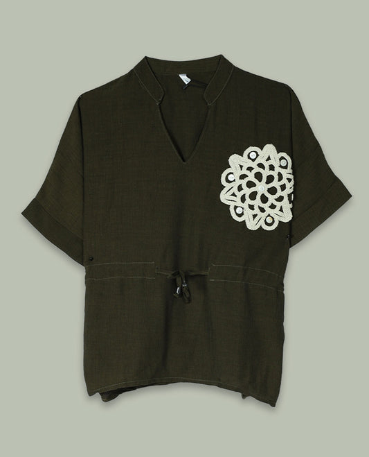 Olive green short-sleeve top with V-slit band neckline, contrast ivory crochet motif on one side, and adjustable drawstring detail at the waist.