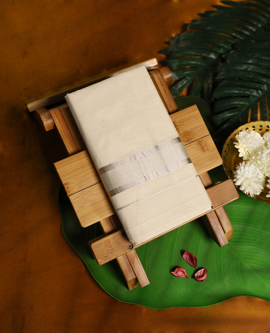 Traditional off white colour pure cotton dhoti featuring a subtle silver tissue border, exuding refined elegance and comfort, perfect for festive rituals, temple visits, and cultural celebrations.
