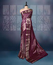 Grape colour semi silk brocade saree featuring intricate golden zari floral and geometric patterns all over the body, complemented by a rich self-colour woven border and pallu, paired with a matching blouse.