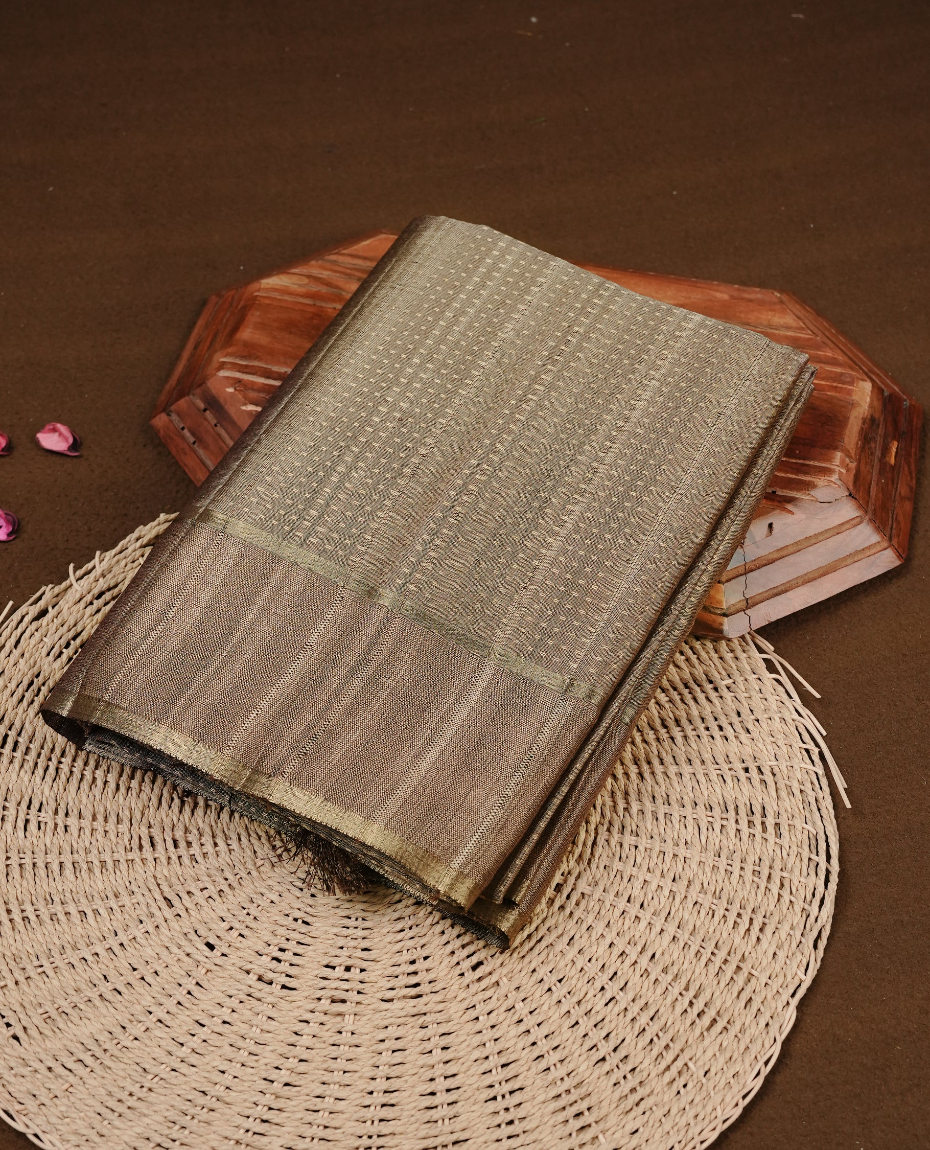 Antique gold colour semi tussar silk saree featuring elegant gold zari dotted stripes across the body, enhanced with a rich zari woven border. Comes with a matching blouse piece.