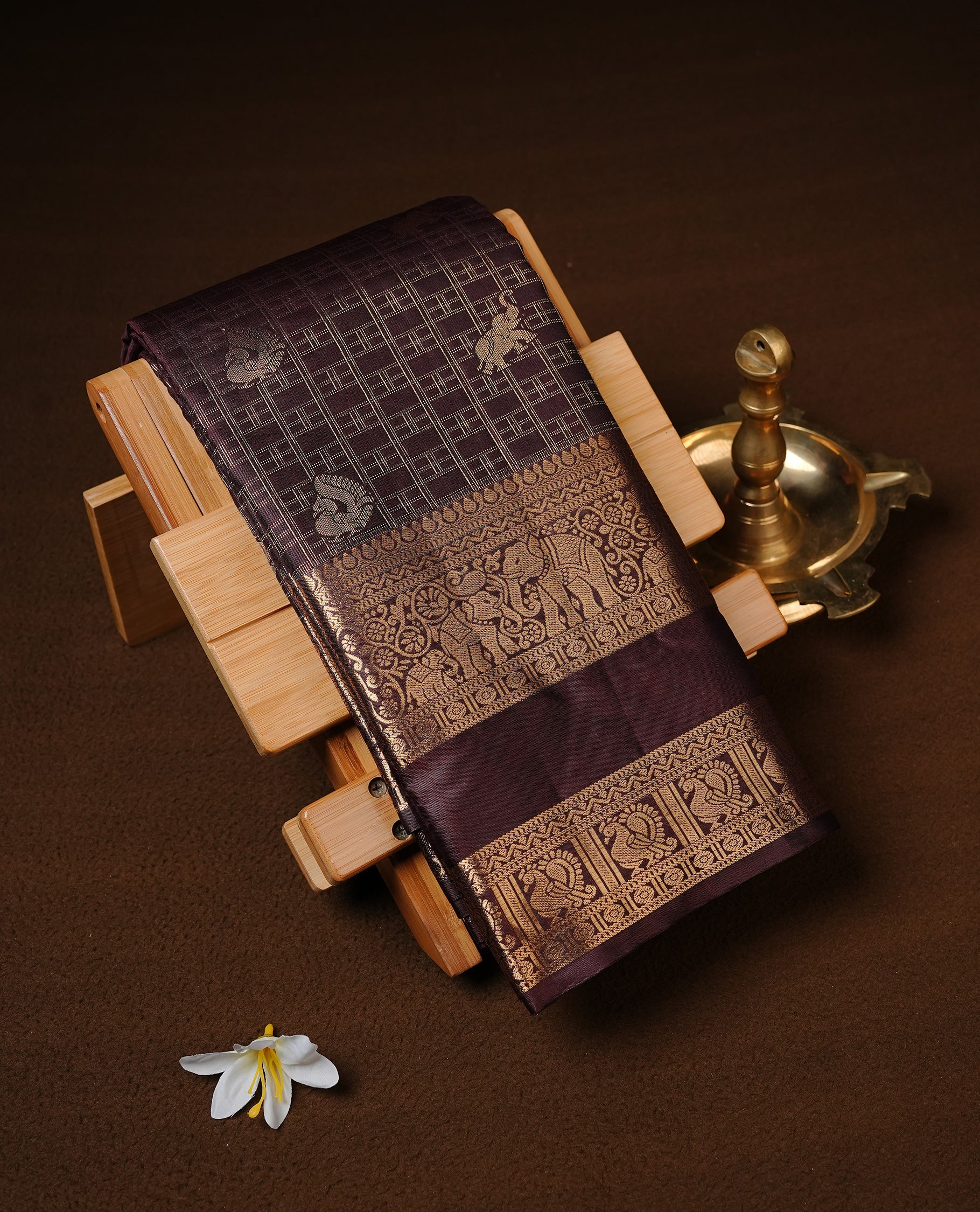 Chocolate Colour Semi Wedding Silk Saree Featuring Gold Zari Checks With Buttas, Showcased with self colour With Traditional Border,  Paired With Matching Blouse Piece.