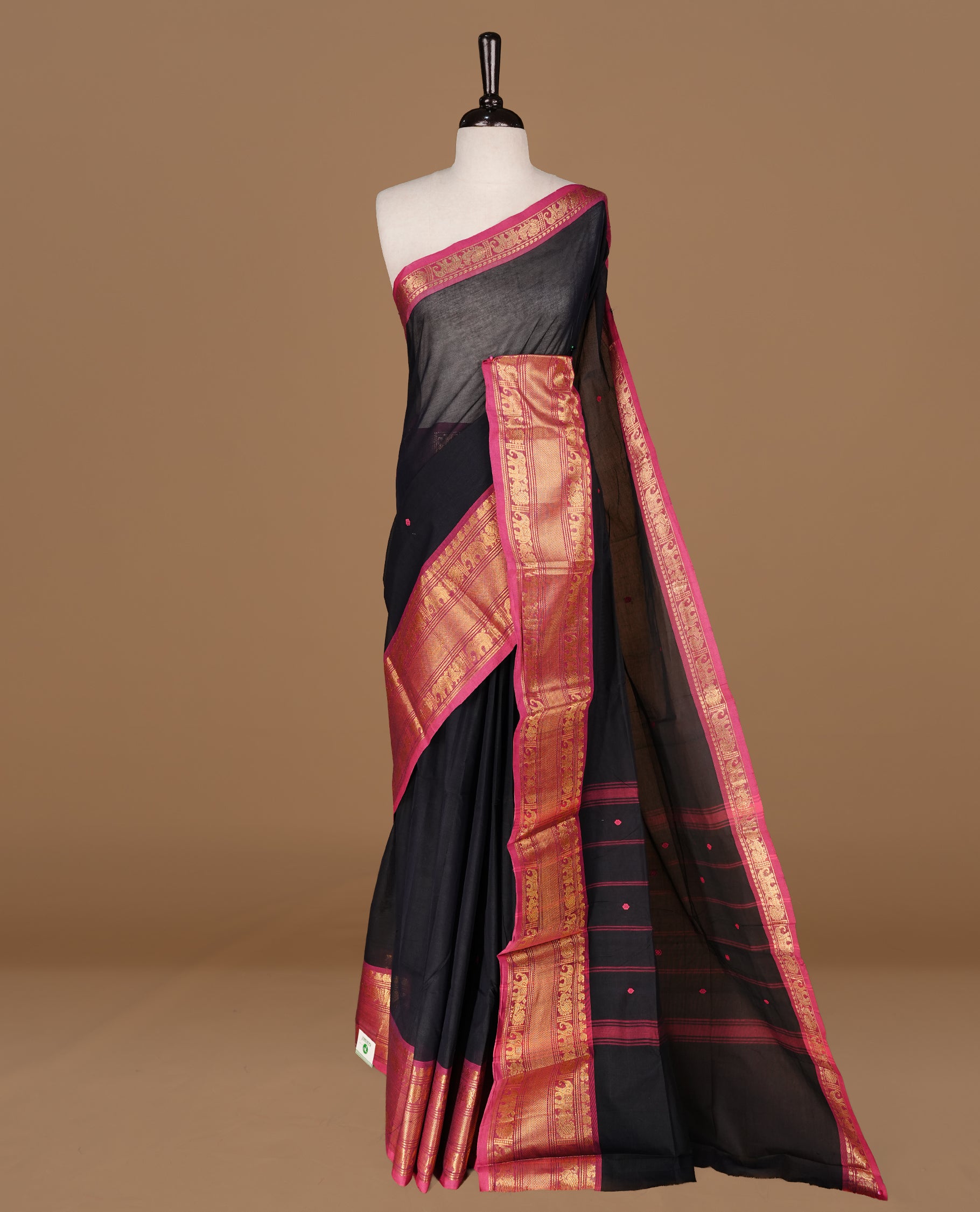 Black colour Chettinad cotton saree featuring motifs on body , complemented by contrast Magenta colour with zari border, comes with matching blouse piece.