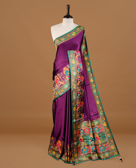 Purple colour Pashmina Saree featuring elegant woven temple and floral motifs, enhanced with a contrast green woven border and a richly detailed traditional pallu, paired with a matching blouse piece.