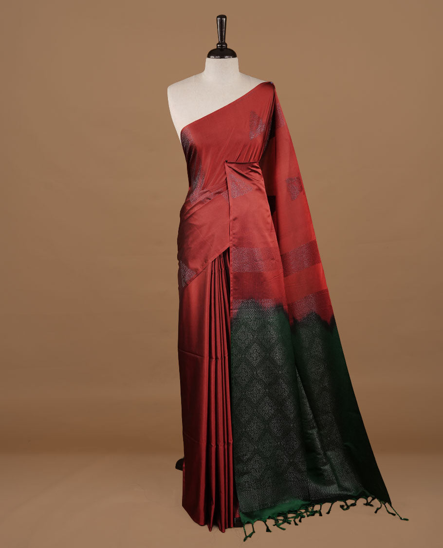 Red colour soft silk saree features a sleek borderless design with intricate antique zari motifs, flowing into a striking contrast green pallu and a matching blouse piece.