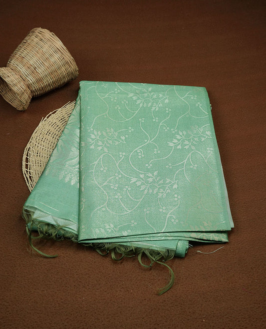 Green colour semi tussar silk saree, featuring an intricate gold zari floral kodi pattern on the body and pallu, comes with matching blouse.