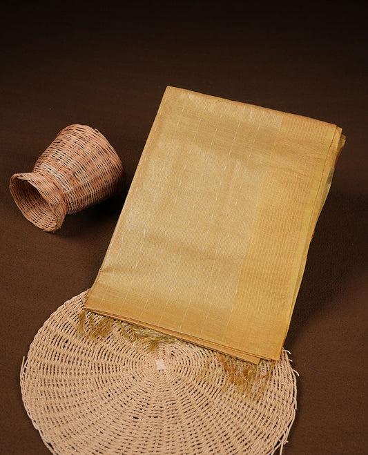 Gold colour semi jute saree highlighting gold zari striped body, without border and paired with matching blouse.