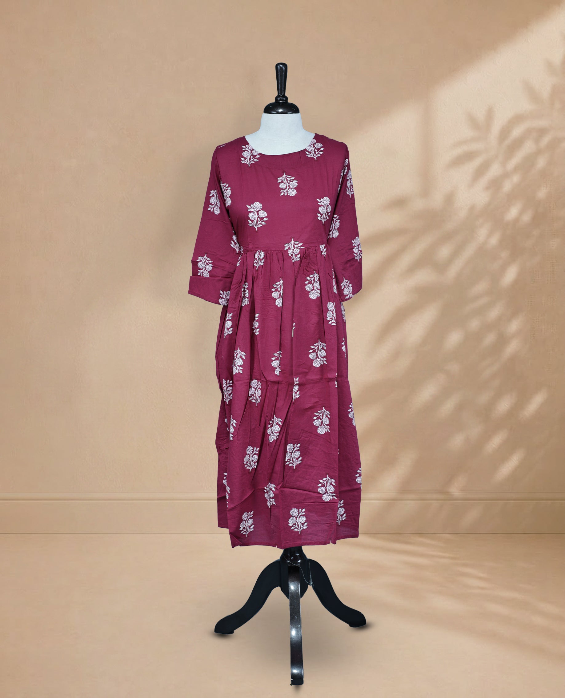 Magenta Green Kurti featuring white digital Floral prints across the body, a round neckline, and a 3/4-sleeve design.