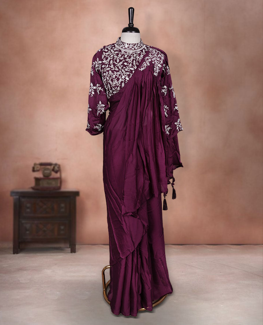 Wine colour ready to wear saree Fearturing intricate silver embroidery on the pallu, paired with a beats and thread embroidered matching blouse.