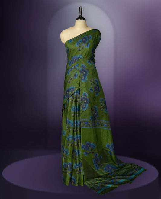 Green colour saree enhanced with a vibrant blue colour floral prints on body & pallu, and  comes with a matching blouse.