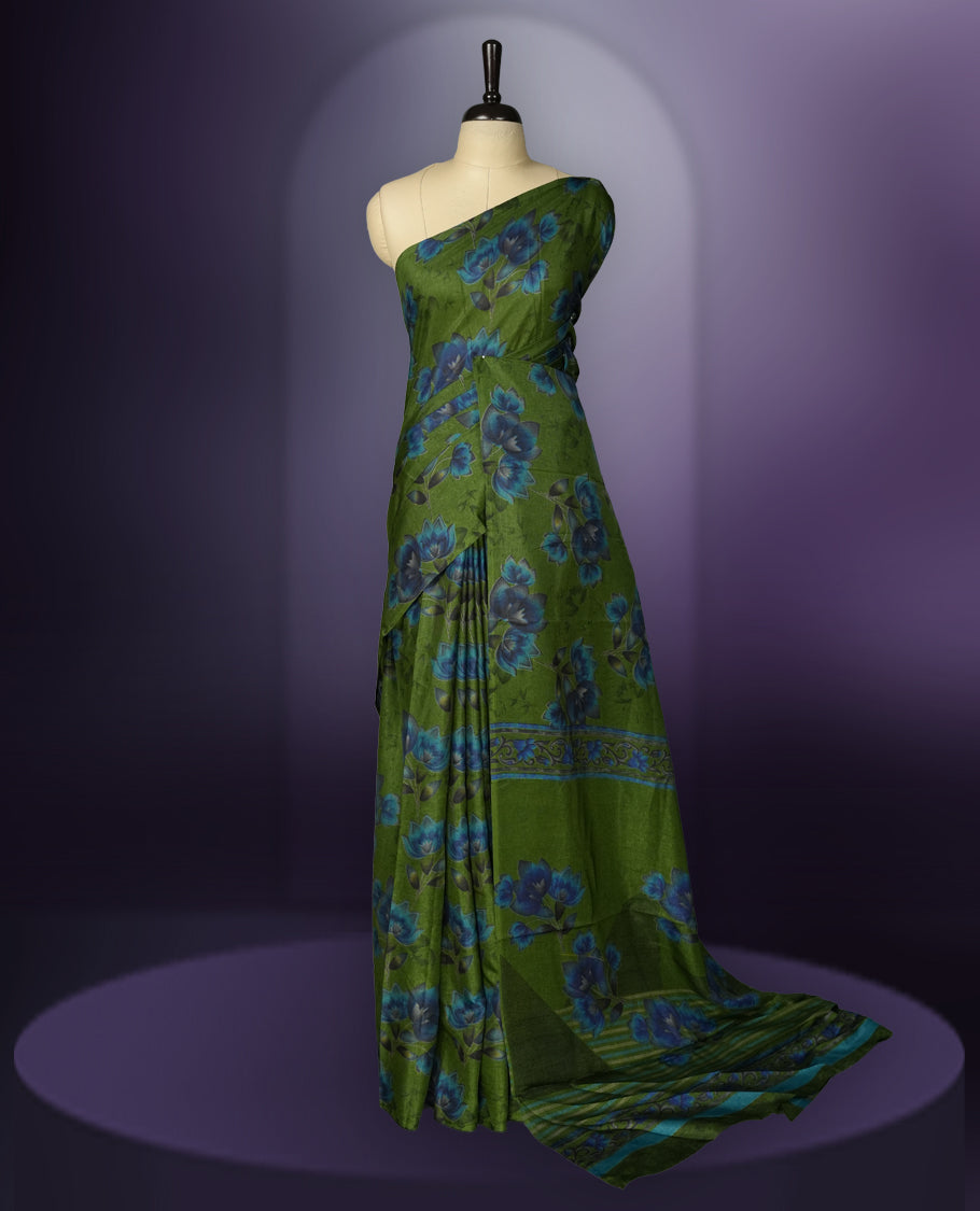 Green colour saree enhanced with a vibrant blue colour floral prints on body & pallu, and  comes with a matching blouse.